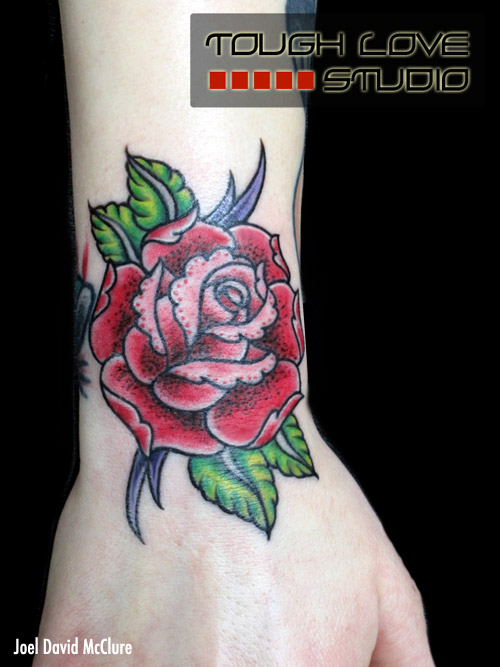 Red rose wrist tattoo